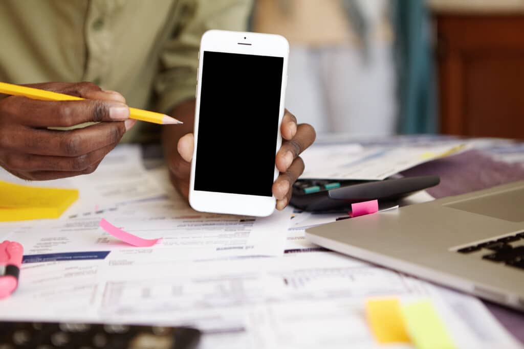 Image showing someone holding up a mobile phone representing mobile first design
